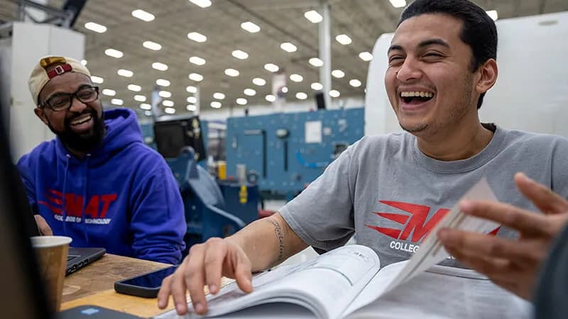 UTI student inspects and tests a heavy-duty diesel engine on a white semi.