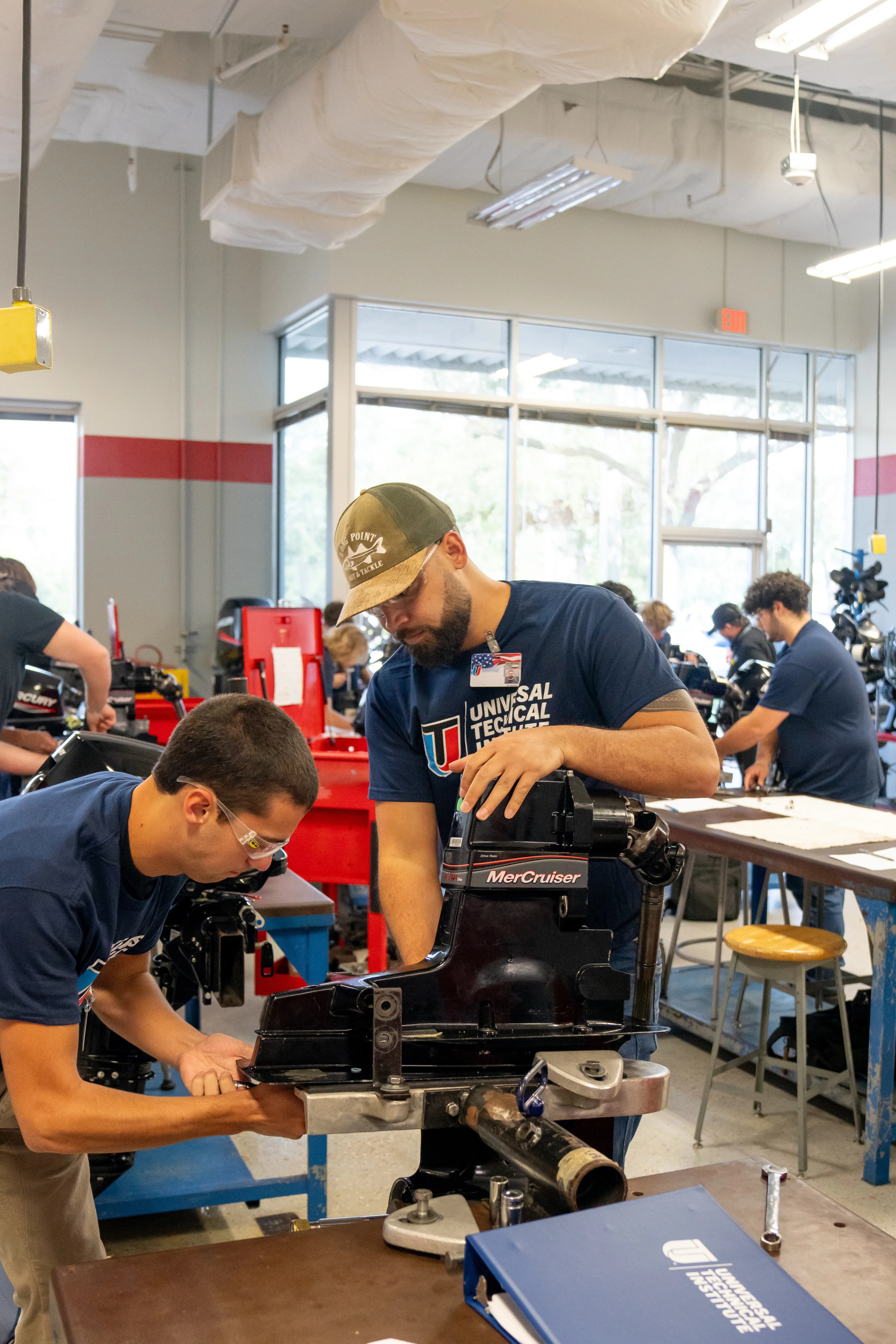 UTI student inspects and tests a heavy-duty diesel engine on a white semi.