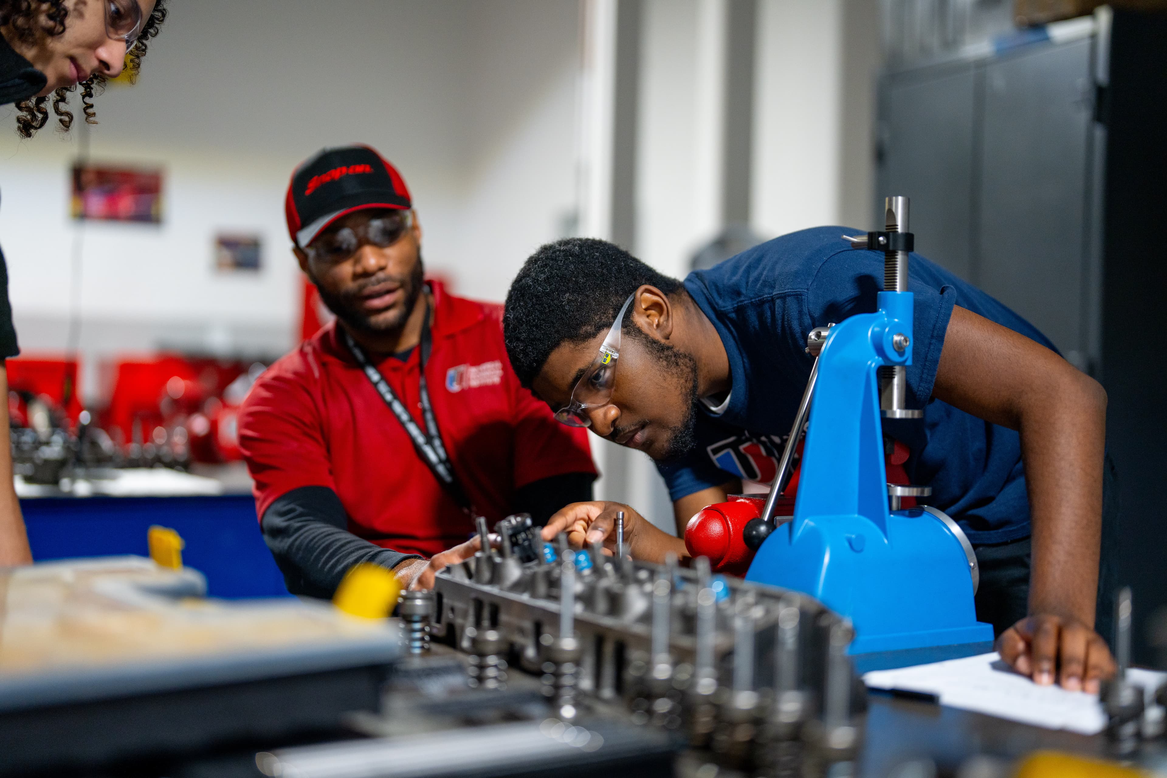 UTI student inspects and tests a heavy-duty diesel engine on a white semi.