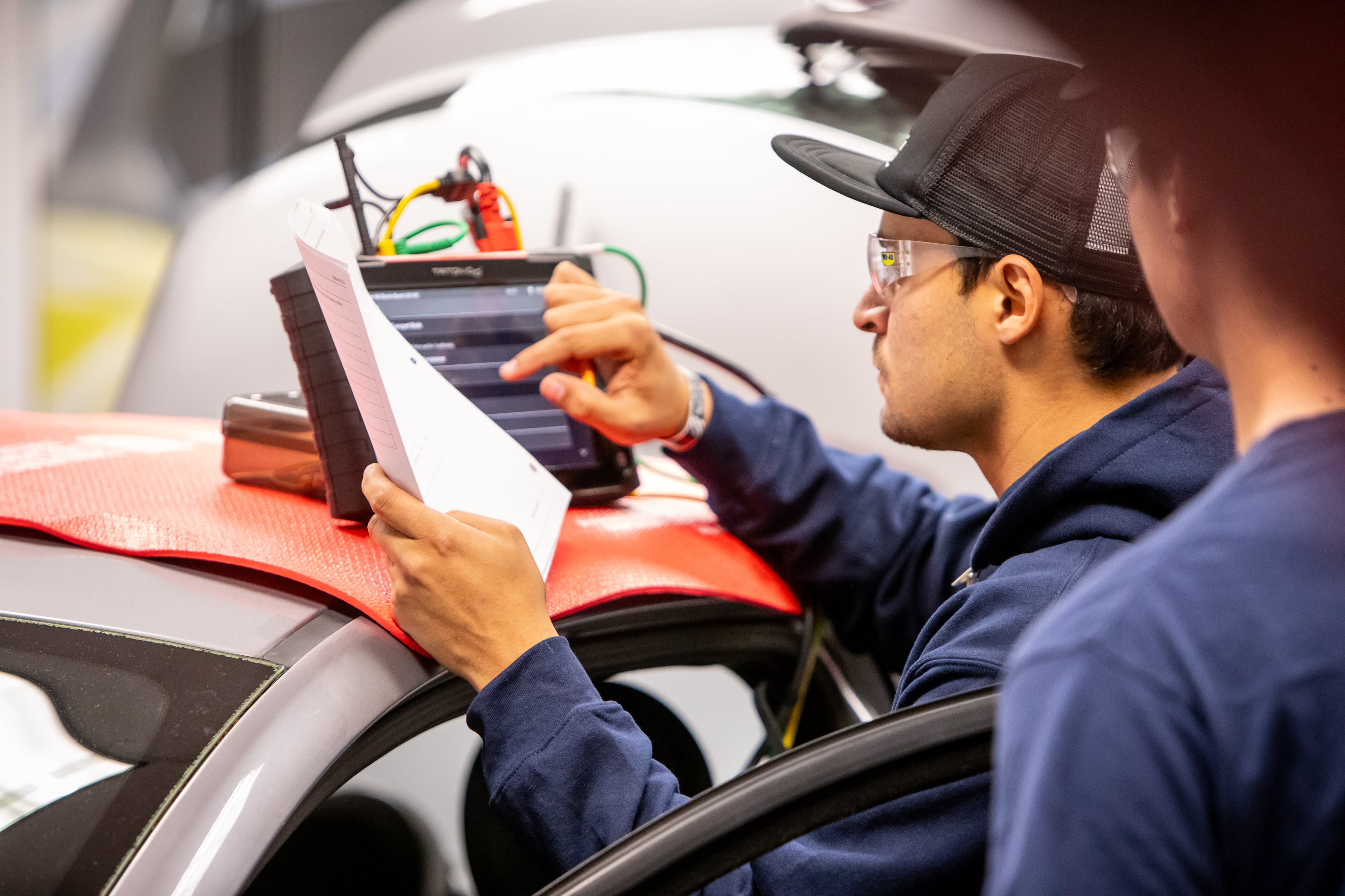 UTI student inspects and tests a heavy-duty diesel engine on a white semi.